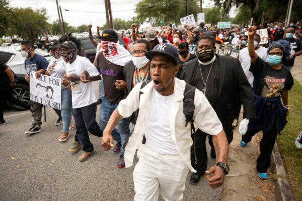 Malik Muhammad (C) joins a group of people marching from the Glynn County Courthouse in downtown to a police station after a rally to protest the shooting of Ahmaud Arbery, in Brunswick, Ga., on May 16, 2020. (Stephen B. Morton/AP Photo)