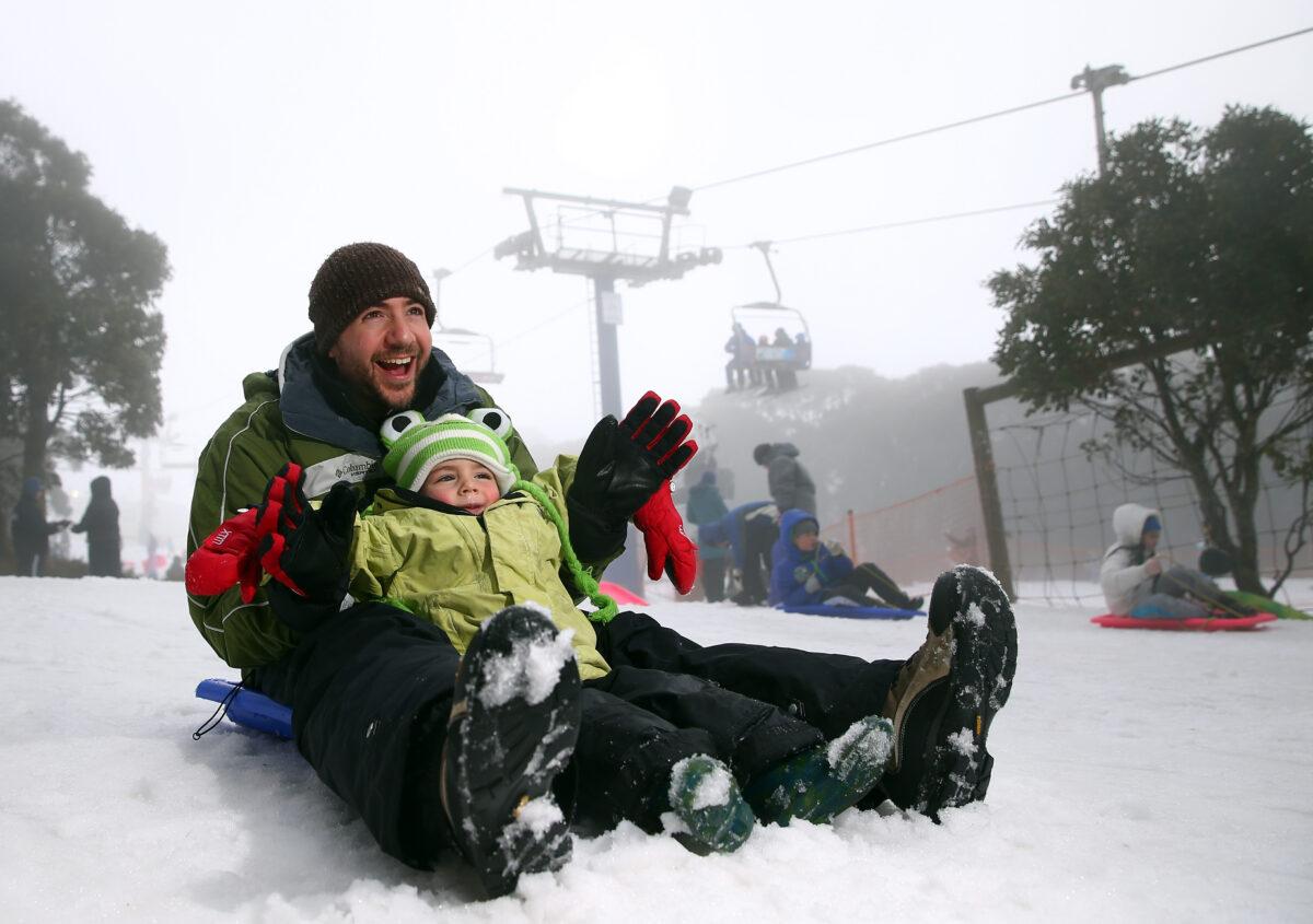 Dad and son snow play on the toboggan on July 11, 2015 in Mount Buller, Australia. (Robert Cianflone/Getty Images)