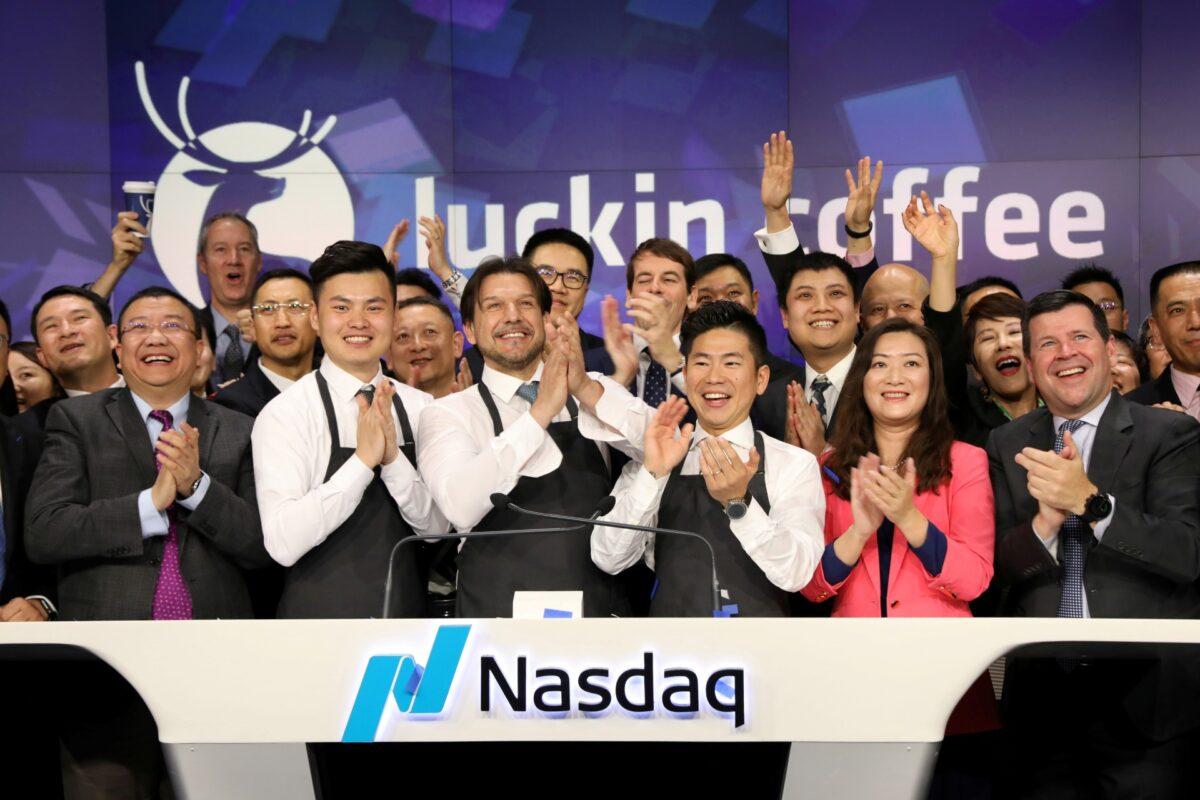 Jenny Qian Zhiya, CEO of Luckin Coffee, and Charles Zhengyao Lu, non-executive chairman of Luckin Coffee, ring the Nasdaq opening bell with employees to celebrate the company's IPO at the Nasdaq Market site in New York on May 17, 2019. (Brendan McDermid/Reuters)