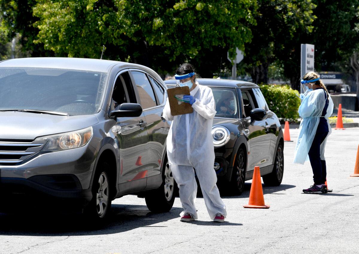 Workers perform testing on drivers in Los Angeles, Calif. on May 13, 2020. (Kevin Winter/ Getty Images)