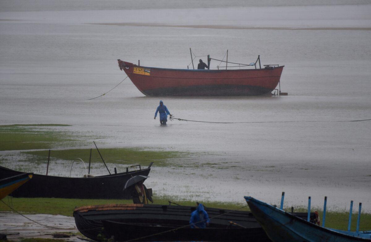Fishermen tie their boats along the shore during rain before Cyclone Amphan makes its landfall, in the Baleswar district of the eastern state of Odisha, India, on May 20, 2020. (Stringer/Reuters)