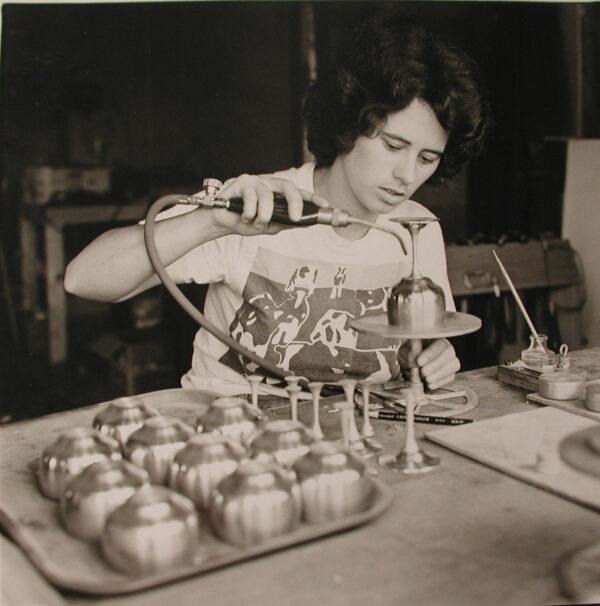 Judi Danforth solders the stems onto pewter wine glasses. (Danforth Pewter)