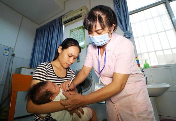 A child receives a vaccination shot at a hospital in Rongan in China's southern Guangxi region on July 23, 2018. That year, a scandal rocked China as a Chinese company was found to have shipped more than 250,000 doses of a faulty DTap vaccine, affecting more than 200,000 children. (AFP via Getty Images)