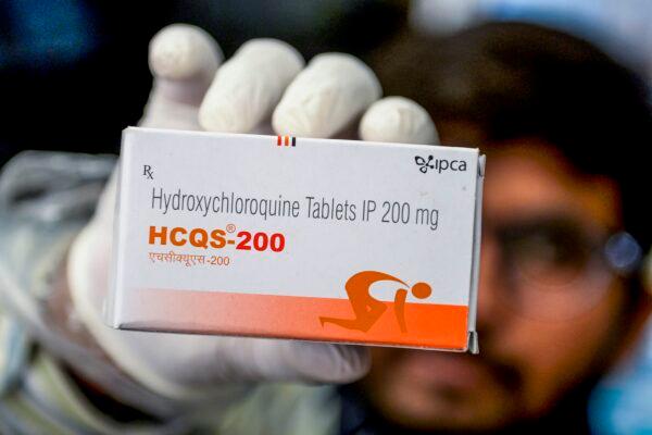 A pharmacist displaying a box of hydroxychloroquine (HCQ) tablets in his store in Hyderabad on April 28, 2020. (Noah Seelam/AFP via Getty Images)