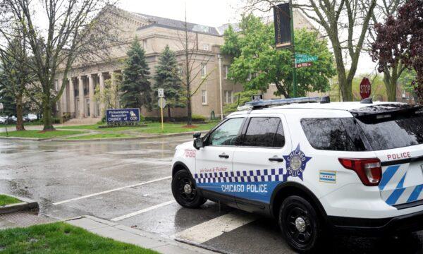 A police car drives by Philadelphia Romanian Church of God in Chicago on May 17, 2020. (Cara Ding/The Epoch Times)