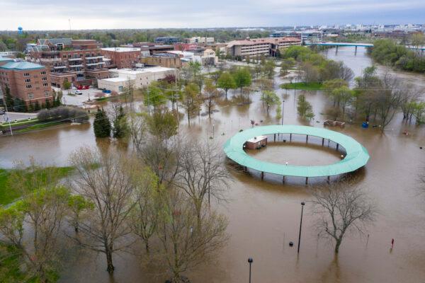 Water floods the Midland Area Farmers Market and the tridge along the Tittabawassee River in Midland on May 19, 2020. (Kaytie Boomer/MLive.com via AP News)