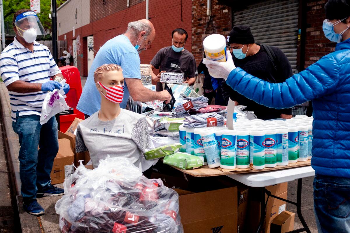 A man sells face masks and disinfection wipes on a street-side table in the Elmhurst neighborhood of Queens in New York City, N.Y. on May 18, 2020. (Johannes Eisele/AFP via Getty Images)