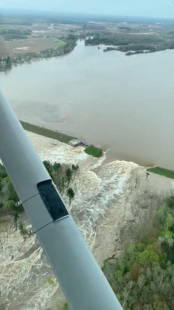 Aerial view of water from a broken Edenville Dam seen flooding the area as it flows towards Wixom Lake in Michigan, in this still frame obtained from social media video dated May 19, 2020. (Ryan Kaleto/via Reuters)
