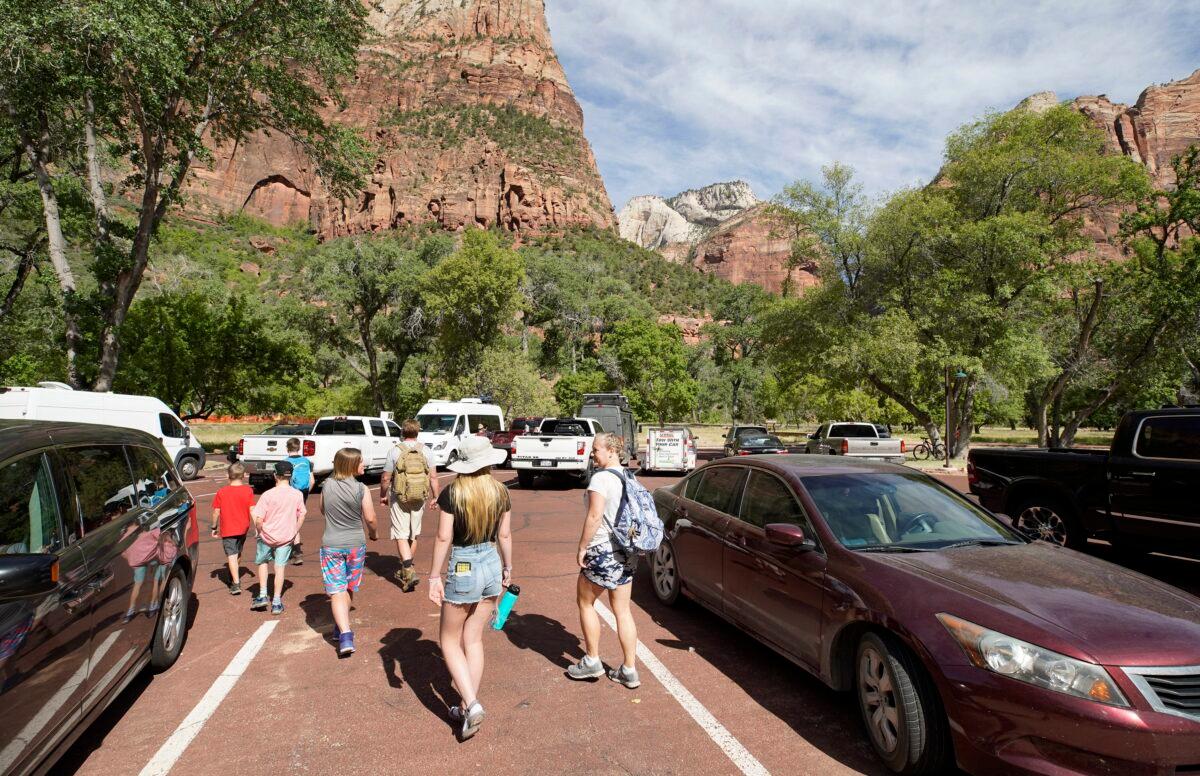 Visitors leave the Zion Lodge parking lot to go on a hike in Zion National Park in Springdale, Utah on May 15, 2020. (George Frey/Getty Images)