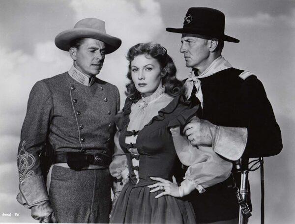 (L–R) Ronald Reagan, Rhonda Fleming, and Bruce Bennett in 1951’s “The Last Outpost.” (Paramount Pictures)