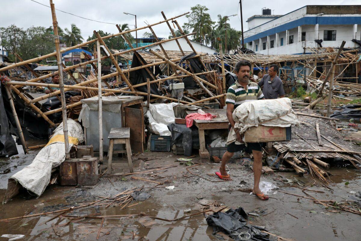 A man salvages his belongings from the rubble of a damaged shop after Cyclone Amphan made its landfall, in South 24 Parganas district in the eastern state of West Bengal, India, on May 21, 2020. (Rupak De Chowdhuri/Reuters)
