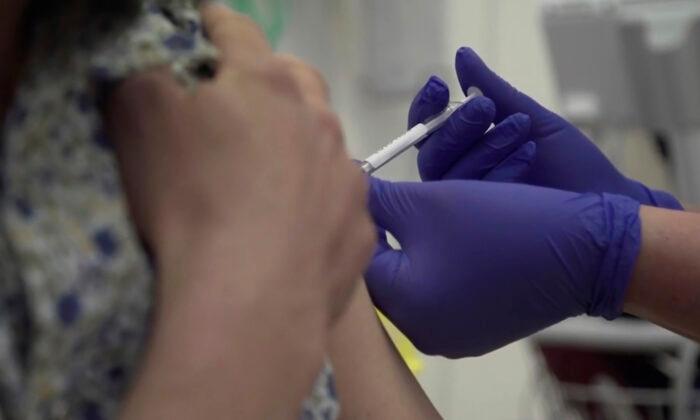 A person being injected as part of the first human trials in the UK to test a potential CCP virus vaccine, at Oxford University, England, on April 23, 2020. (Oxford University Pool via AP)