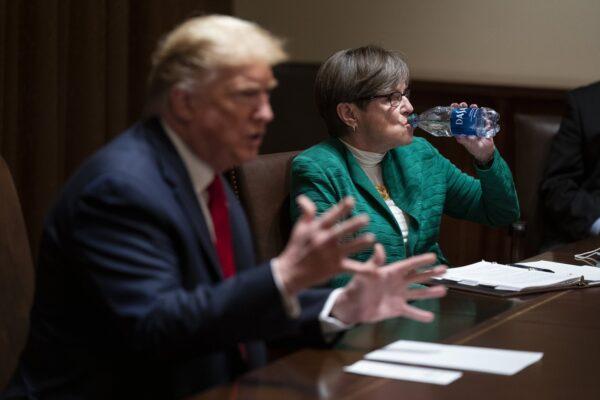 Gov. Laura Kelly (D-Kan.) listens as President Donald Trump speaks during a meeting in the Cabinet Room of the White House in Washington on May 20, 2020. (Evan Vucci/AP Photo)