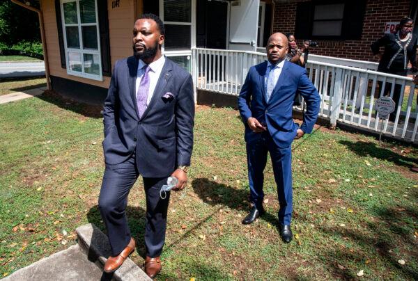 Lee Merritt, left, and Chris Stewart, attorneys for the mother of Ahmaud Arbery, are seen at a news conference in East Point, Georgia, on May 19, 2020. (Ron Harris/AP)