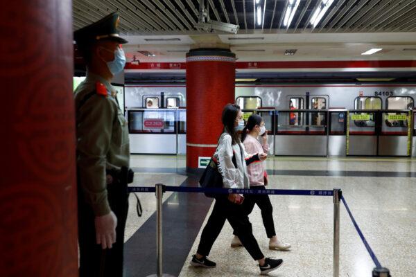 A Paramilitary police officers keeps watch at a station of Line 1 of the metro that runs past the Great Hall of the People, the venue of the upcoming National People's Congress (NPC) in Beijing, China May 19, 2020. (Thomas Peter/Reuters)