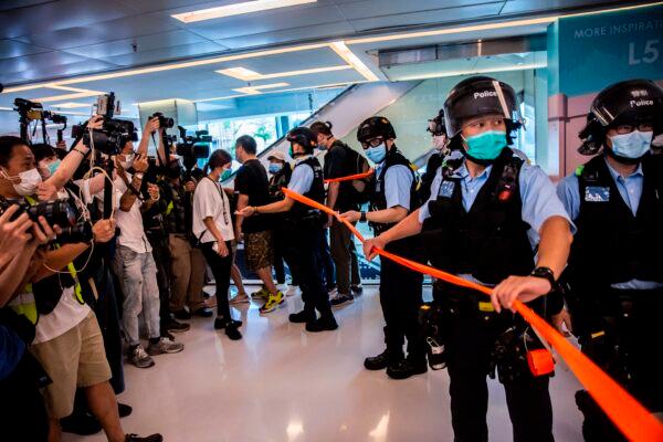 Police (R) take part in a clearence operation during a pro-democracy demonstration calling for the city's independence at a mall in Hong Kong on May 16, 2020. (Isaac Lawrence/AFP via Getty Images)