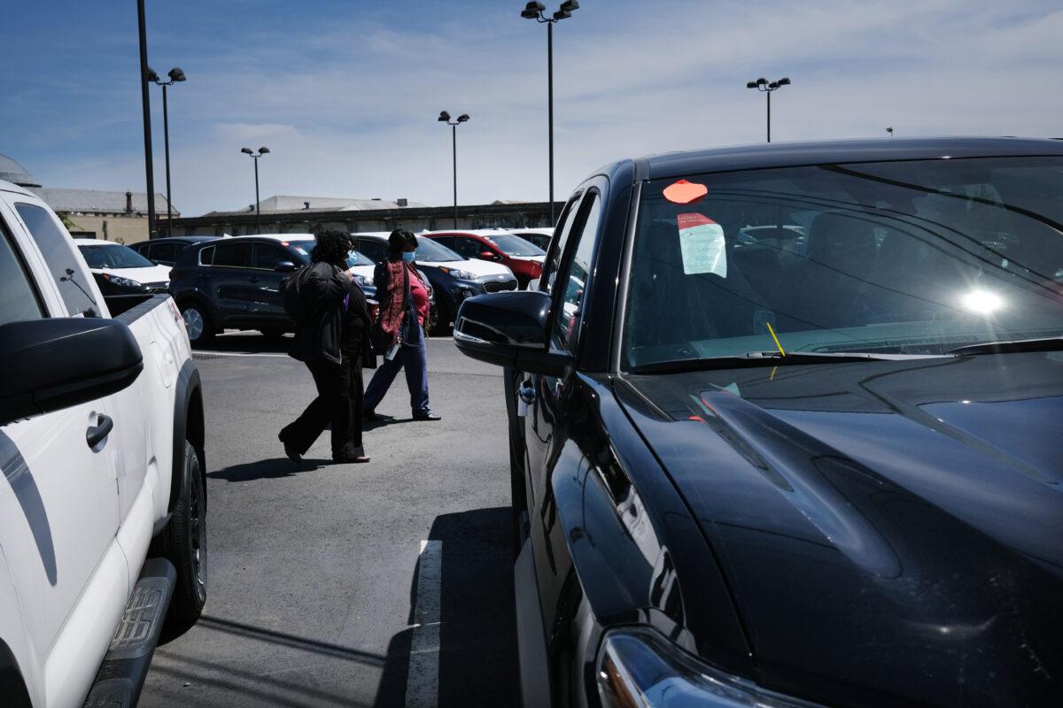 People visit a car dealership on the first day dealerships were allowed to resume operations, in Linden, N.J., on May 20, 2020. (Spencer Platt/Getty Images)