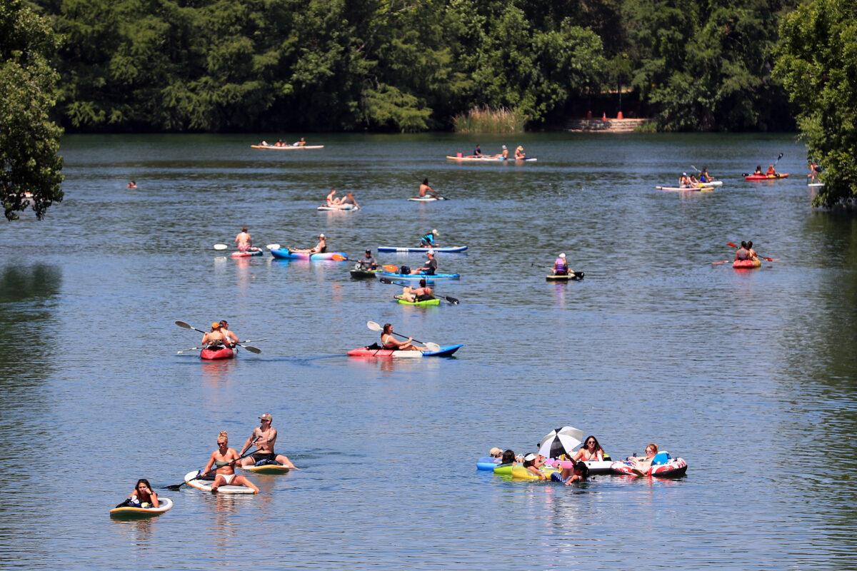 Residents swim, paddleboard, and kayak in Barton Creek in Austin, Texas, on May 20, 2020. (Tom Pennington/Getty Images)