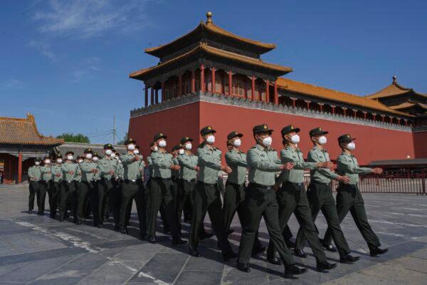 The paramilitary police officers march outside the Forbidden City, near Tiananmen Square in Beijing, China on May 20, 2020. (Kevin Frayer/Getty Images)