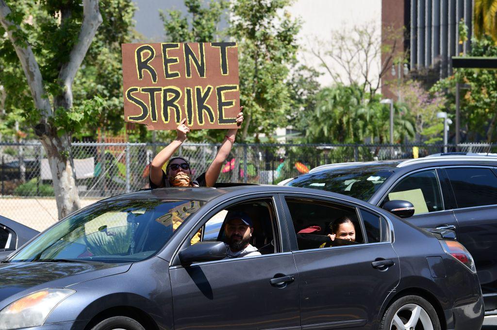 Demonstrators call for a rent strike during the COVID-19 pandemic as they pass City Hall in Los Angeles, Calif., on May 1, 2020. (Frederic J. Brown/AFP via Getty Images)