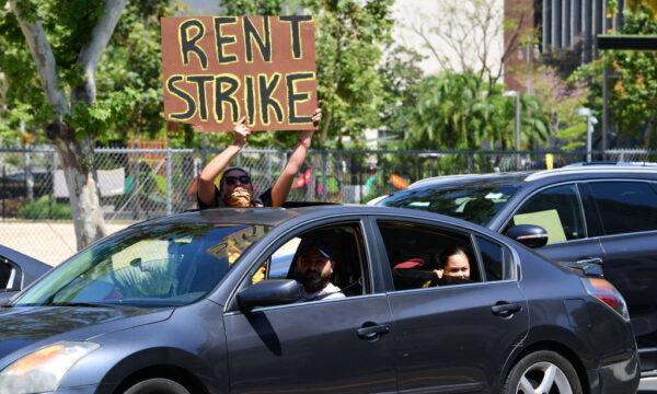  Demonstrators call for a rent strike during the COVID-19 pandemic as they pass City Hall in Los Angeles, Calif., on May 1, 2020. (Frederic J. Brown/AFP via Getty Images)