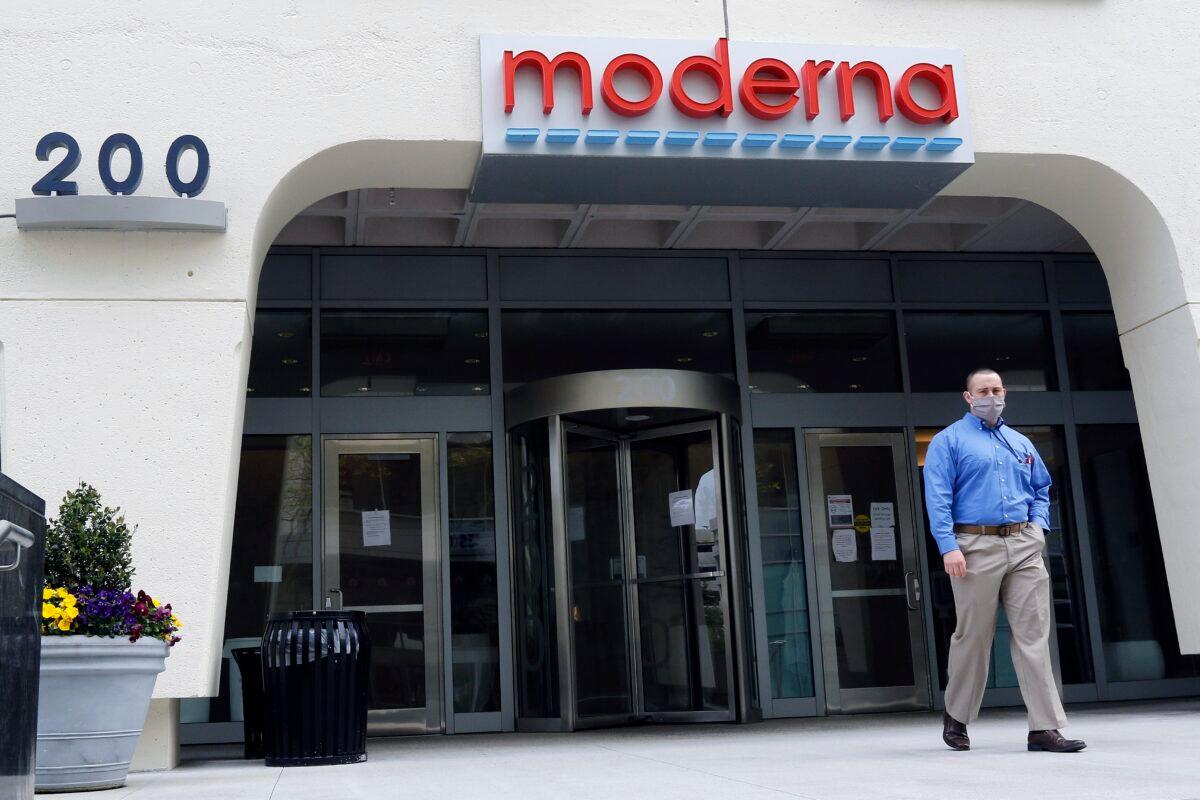 A man stands outside an entrance to a Moderna building in Cambridge, Mass. on May 18, 2020. (Bill Sikes/AP Photo)