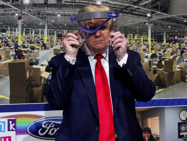 President Donald Trump poses with a protective face shield that was handed to him during a tour at the Ford Rawsonville Components Plant, which is making ventilators and medical supplies, during the CCP virus pandemic in Ypsilanti, Michigan, on May 21, 2020. (Leah Millis/Reuters)