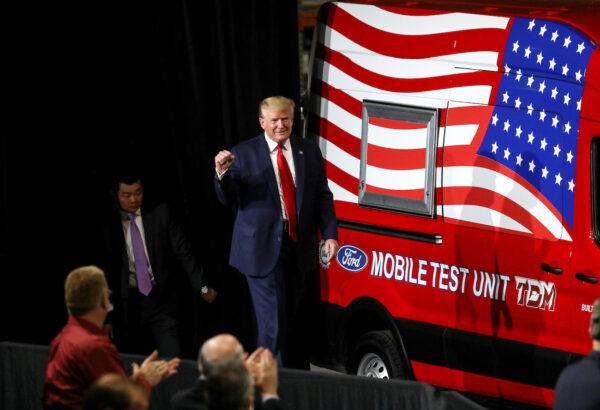 President Donald Trump walks past a mobile test vehicle as he arrives to speak during a visit at the Ford Rawsonville Components Plant, after it reopened from the CCP virus restrictions in Ypsilanti, Michigan, on May 21, 2020. (Leah Millis/Reuters)