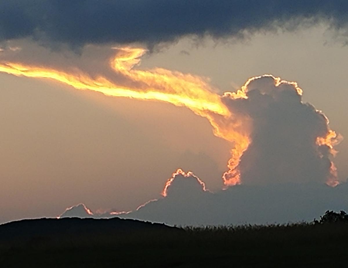 Fire-breathing dragon in the clouds over Lake Travis, Lago Vista, Texas, in 2018. (Caters News)