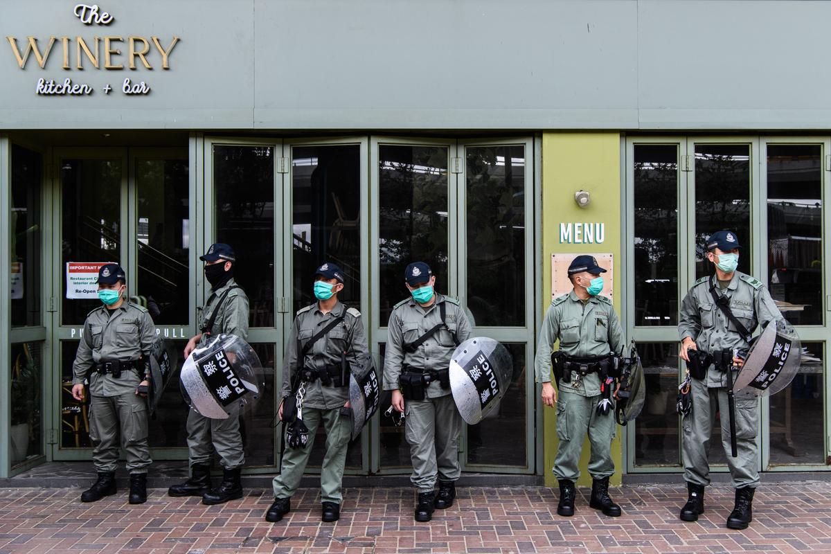 Riot police stand guard near a group of pro-democracy protesters in Hong Kong on May 22, 2020. (Anthony Wallace/AFP via Getty Images)