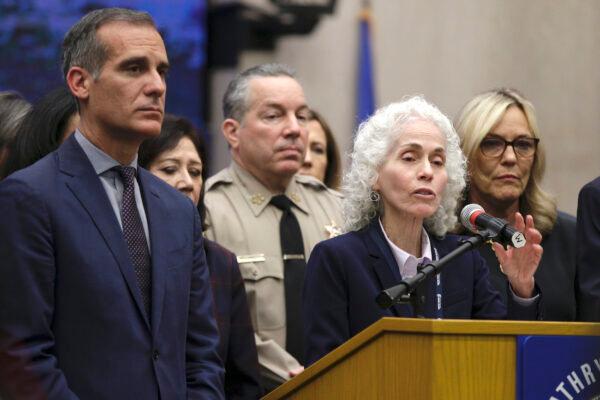 Los Angeles County Public Health Director Barbara Ferrer, at podium, speaks at a news conference with Los Angeles Mayor Eric Garcetti (L), in Los Angeles on March 12, 2020. (Damian Dovarganes/AP Photo)