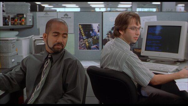 Ajay Naidu (L) and David Herman play workers who hate their jobs, in “Office Space.” (20th Century Fox)