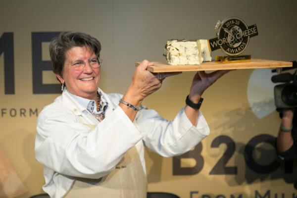 Supreme Jury judge Cathy Strange with Rogue River Blue after it took top prize at the 2019 World Cheese Awards in Bergamo. (Tim Johnston Photography/Guild of Fine Food)