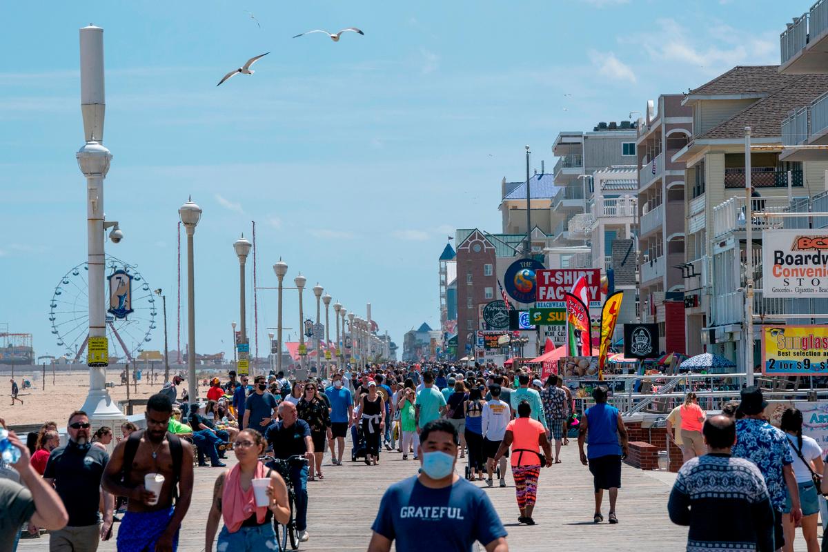 People enjoy the boardwalk during the Memorial Day holiday weekend amid the CCP virus pandemic in Ocean City, Md., on May 23, 2020. (Alex Edelman/AFP via Getty Images)