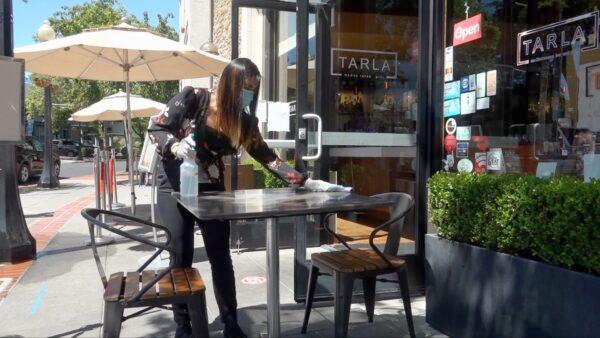 Employees clean every half hour at Tarla Mediterranean Bar and Grill in Napa on May 23, 2020. (Ilene Eng/The Epoch Times)