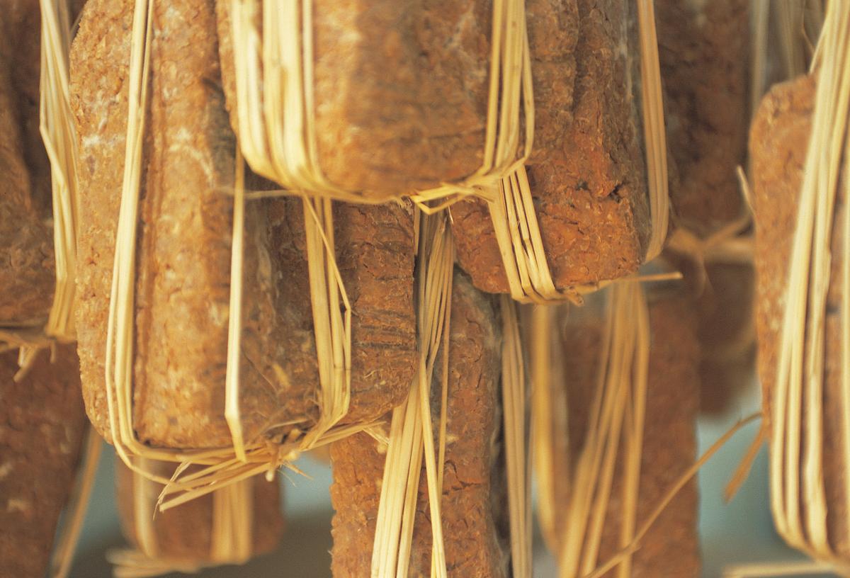 Meju, blocks of soaked, boiled, and pressed soybeans that are tied with straw and hung to dry and ferment. These are the literal building blocks of soy sauce and doenjang. (Courtesy of Mac Doenjang)