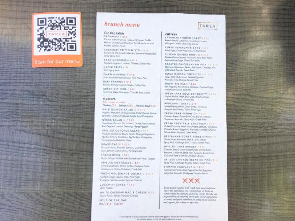 People can scan the QR code to see the menu on their phone or ask for a one-time use menu at Tarla Mediterranean Bar and Grill in Napa, Calif., on May 23, 2020. (Ilene Eng/The Epoch Times)