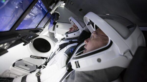 SpaceX astronauts Doug Hurley, foreground, and Bob Behnken work in SpaceX's flight simulator at the Kennedy Space Center in Cape Canaveral, Fla., on March 19, 2020. (SpaceX via AP)