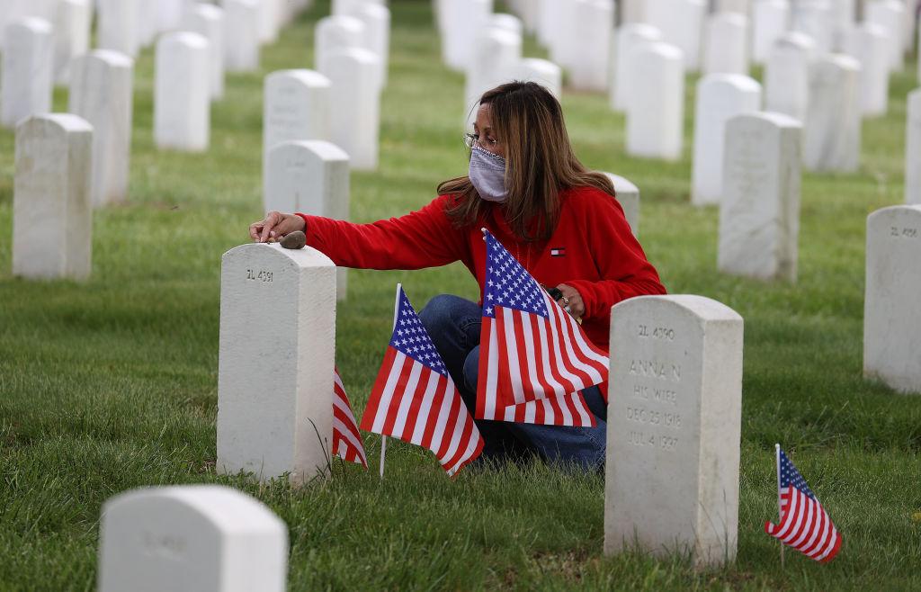 Louise Lombardi of Baldwin, N.Y., visits the gravesite of her father Joseph Lombardi who was a World War II Veteran at Long Island National Cemetery on May 24, 2020, in Farmingdale, N.Y. (Al Bello/Getty Images)