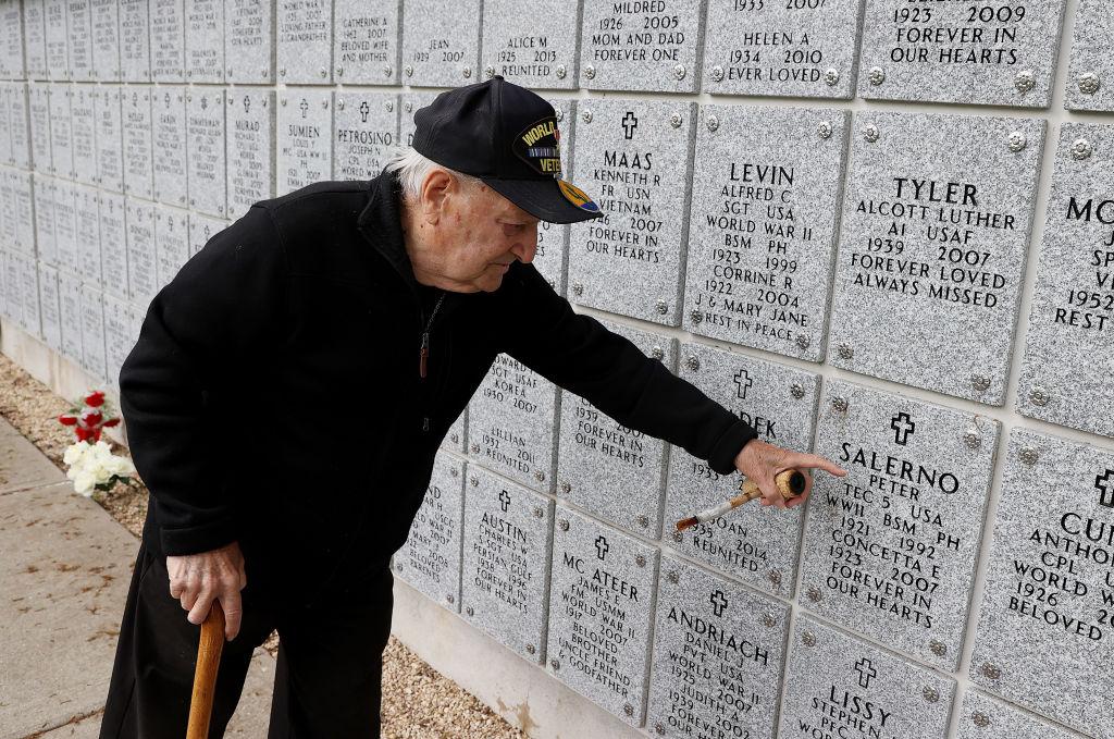 World War II Army Veteran Angelo Salerno points to the gravesite of his brother Peter Salerno who also served in World War II at Long Island National Cemetery on May 24, 2020 in Farmingdale, N.Y. (Al Bello/Getty Images)