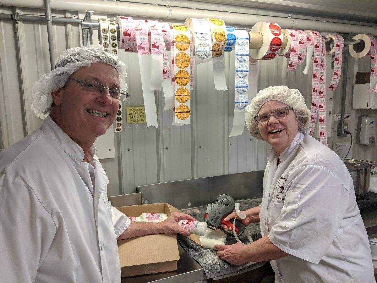 Steve and Susanne Messmer, Pete's parents, pack cheese donations for food pantries at Lively Run Dairy. (Courtesy of Lively Run Dairy)
