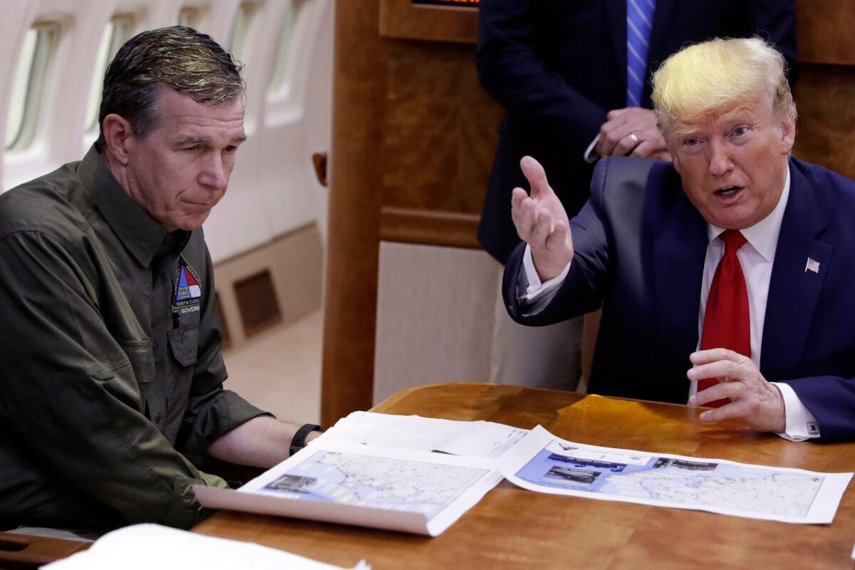 President Donald Trump, right, participates in a briefing about Hurricane Dorian with North Carolina Gov. Roy Cooper aboard Air Force One at Marine Corps Air Station Cherry Point in Havelock, N.C., on Sept. 9, 2019. (Evan Vucci/AP Photo)