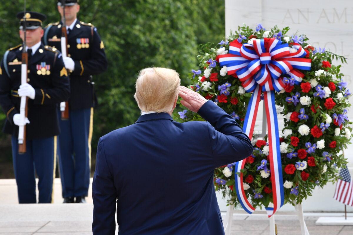 President Donald Trump salutes as he participates in a Wreath-Laying Ceremony at the Tomb of the Unknown Soldier at Arlington National Cemetery to commemorate Memorial Day in Arlington, Va., on May 25, 2020. (Nicholas Kamm/AFP via Getty Images)