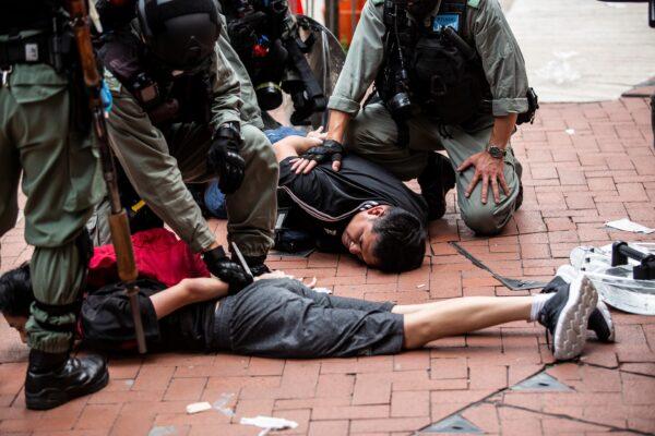 Pro-democracy protesters are arrested by police in the Causeway Bay district of Hong Kong ahead of planned protests against a proposal to enact new security legislation in Hong Kong, on May 24, 2020. (Isaac Lawrence/AFP/Getty Images)
