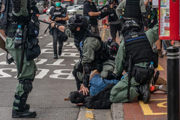 A pro-democracy supporter is detained by riot police during an anti-government rally in Hong Kong on May 24, 2020. (Anthony Kwan/Getty Images)