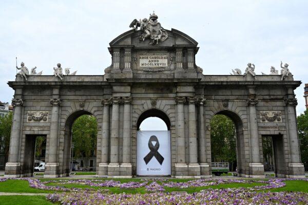 A black ribbon commemorating CCP virus victims hangs on the Puerta de Alcala in Madrid, Spain, on April 23, 2020. (Gabriel Bouys/AFP/Getty Images)