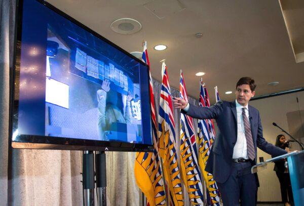B.C. Attorney General David Eby gestures while showing a video of bundles of cash brought to a casino by an individual, during a news conference in Vancouver on June 27, 2018.  (The Canadian Press/Darryl Dyck)