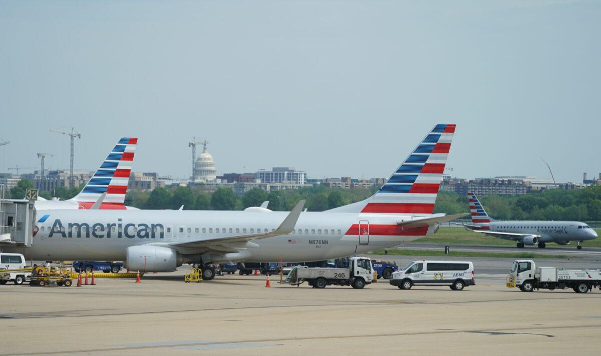 An American Airlines Boeing 737 jet sits at a gate at Washington's Reagan National airport with the U.S. Capitol building in the background, in Washington on April 29, 2020. (Kevin Lamarque/Reuters)