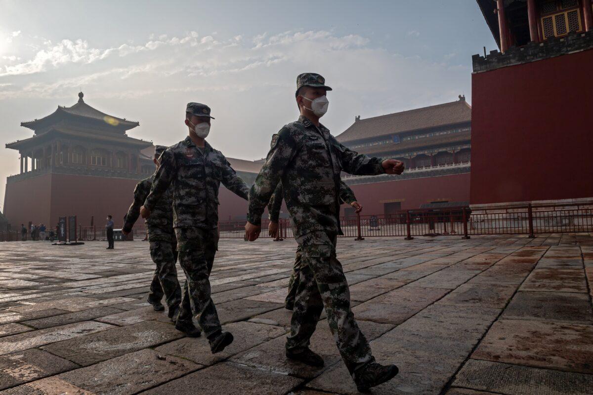 China’s People's Liberation Army soldiers march next to the entrance to the Forbidden City during the opening ceremony of the Chinese People's Political Consultative Conference in Beijing on May 21, 2020. A report analyzed the dependency of five democratic countries on China and recommended decoupling from the increasingly belligerent Asian nation. (Nicolas Asfouri/AFP via Getty Images)