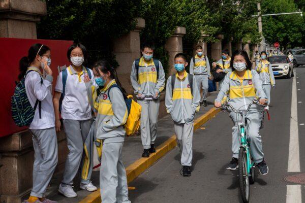 Students leave a middle school in Beijing, China on May 11, 2020. (NICOLAS ASFOURI/AFP via Getty Images)